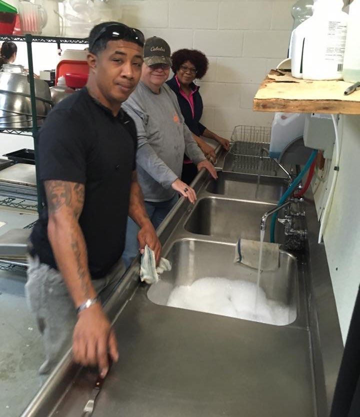 Jason and fellow volunteers serving Thanksgiving meals to neighbors in need.