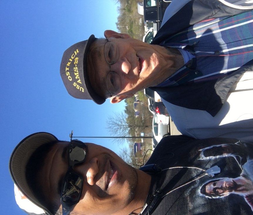 Selfie of Jason with a smiling World War II veteran wearing a Navy ship cap.